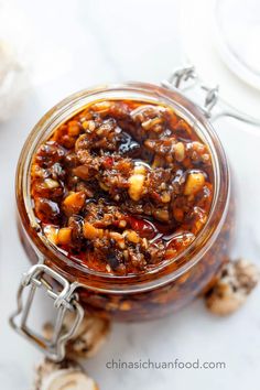 a glass jar filled with food sitting on top of a table