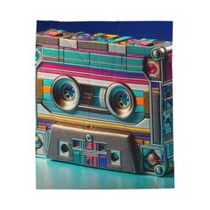 a multicolored cassette tape recorder bag on a blue surface with an image of the cassette player