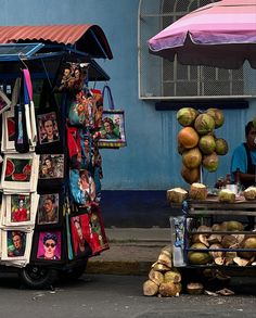 a cart with pictures on it sitting in front of a blue building