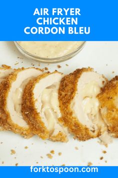 chicken cordon bleu is cut in half and ready to be served with sauce