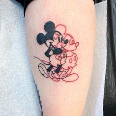 a person with a mickey mouse tattoo on their leg