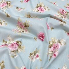 a blue floral print fabric with pink and white flowers on the bottom half of it