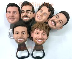 a group of men's head cut out with scissors in the shape of heads