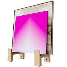 a wooden stand with a pink and white square on it's back end, in front of a white background