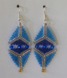 Blue Diamond-Shaped Beaded Earrings with Crystals sparkle with two shades of blue and silver beads, blue crystals and a light gold drop. Elegant in their simplicity, they are extremely lightweight and comfortable to wear all day and into the evening. Look elegant, feel elegant when you wear them. You are so worth it. They will be outstanding with any evening wear and just plain dressy-funky with jeans.  Carefully handwoven with premium Myorki Delica glass beads, all materials are of the highest quality for durability and beauty, and are finished with stainless steel ear wires. Need different colors? They come in several colors or I can make custom earrings easily for you. Just let me know the colors you desire and I'll make it happen, just for you. Handwoven Jewelry, Walmart Coupon, Earrings With Crystals, Coupon Card, Coupon Websites, Custom Earrings, Beaded Dangle Earrings, Diamond Shaped, Big Deal