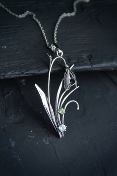 ITEM DESCRIPTION: The size H 5 cm x W 3 cm (2 x 1 1/3 inch). Weight - 3 g. You can buy it with a silver chain or without it. I made this spring flower pendant of sterling silver, blue topaz, and peridot. Silver snowdrop looks gentle and elegant. It will be a great addition to your jewelry collection. Expect many compliments on this! This handmade necklace will come to you in a gift box - ready for gifting. The parcel will be sent during 1-2 days after payment. Delivery usually takes 10-21 days. Nature-inspired Flower Charm Pendant Necklace, Silver Nature-inspired Necklace With Flower Charm, Nature-inspired Silver Flower Necklace With Charm, Nature-inspired Flower Charm Pendant Jewelry, Silver Necklace With Nature-inspired Flower Charm, Vintage Silver Necklaces With Birth Flower, Vintage Silver Birth Flower Necklace, Vintage Silver Necklace With Birth Flower, Silver Teardrop Jewelry With Flower Charm