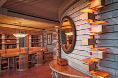 the interior of a restaurant with wooden tables and stools, built into the side of a wall