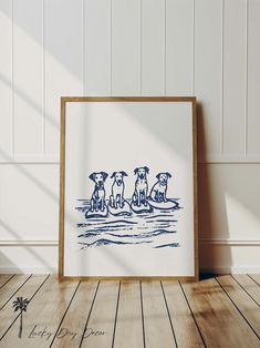 three dogs are sitting on the beach in blue ink