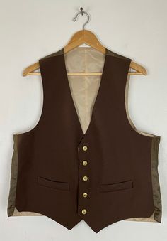 "-Description- >men's dark brown sport coat with matching reversible formal vest >sport coat and vest have gold buttons >sport coat has two button front, three buttons on the cuffs, two flap close and one open pocket on the front, vent in the back, built in shoulder pads, partially lined with print lining >vest is reversible - dark brown on one side, beige on the other >vest has five button front, two open pocket on the front >size 44R >great set for a formal event! >cond Brown Notch Lapel Vest For Business, Brown Buttoned Vest For Formal Occasions, Semi-formal Vest Outerwear For Fall, Brown Business Vest For Fall, Brown Business Vest With Notch Lapel, Formal Brown Vest With Buttons, Tailored Brown Business Vest, Semi-formal Brown Winter Vest, Tailored Brown Vest With Notch Lapel