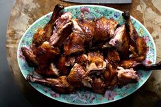 a plate full of cooked chicken on a table