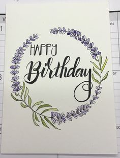 a card with the words happy birthday written in black ink and surrounded by purple flowers