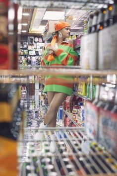 a woman standing in the aisle of a grocery store