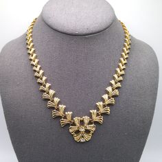 *Description: This is a beautiful gold plated linked necklace with a built in clear rhinestone pendant from the 1960s.  The fold over clasp snaps securely. This would be a great addition to your vintage jewelry collection or make a great vintage gift! *Approximate Measurements: Length - 17 1/2 Inches, Length of Pendant - 1 Inch, Weight - 2 Ounces *Condition: Very good vintage condition.  Will see signs of wear under magnification. See photos for details. *Hallmark:  Unsigned *Item # 5934 Please Vintage Gold Plated Jewelry For Party, Formal Gold Rhinestone Necklace With Jewels, Vintage Jeweled Necklace For Anniversary, Vintage Gold Chain Necklace With 17 Jewels, Vintage Gold Plated Necklaces For Weddings, Vintage Gold Plated Formal Jewelry, Vintage Gold Plated Necklace For Anniversary, Classic Gold Necklaces With Jewels, Vintage Gold Chain Necklace For Party