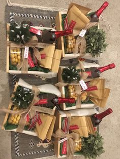 several wine bottles and cheese wrapped in burlap with pine cones on the side