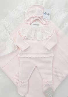 Dress your little one in this adorable light pink 2-piece knitted baby outfit, crafted from a super soft cotton blend. The set includes a long-sleeved top with a decorative white lace collar and back buttons closure, along with matching footed pants. Pair it with the cozy bonnet and matching blanket, sold separately. Made in Spain 50% cotton, 50% acrylic (soft knit) Machine washable in warm water Set includes top and pants If in between sizes, we recommend sizing up White Lace Collar, Knitted Baby Outfits, Knit Machine, Baby Boy Romper, Boys Romper, Knitted Baby, Baby Boy Shoes, Baby Outfit