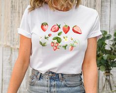 Strawberry Shirt, Botanical Shirt, Fruit Shirt, Aesthetic Clothing, Garden Shirt, Strawberry Tshirt, Strawberry Top Garden Shirt, Womens Tee Welcome to AuroraConceptDesign! ❤️ 👉🏻 PROCESSING TIME: - 3-5 business days. - Please contact with us if there is a rush order. 👉🏻 DELIVERY TIME: - Standard Shipping:  3-5 business days - Expedited Shipping  1-3 business days 👉🏻 CARE INSTRUCTIONS: - Machine wash cold and tumble dry low.  - Do not iron directly onto the design. - Do not bleach. We offer White Strawberry Print Shirt For Spring, Casual Shirt With Plant Print, Casual Strawberry Print Shirt For Spring, White Botanical Shirt For Summer, Cotton Shirt With Strawberry Print For Spring, Casual Fruit Print T-shirt For Spring, Botanical Style Shirt With Relaxed Fit For Summer, Botanical Style Relaxed Fit Shirt For Summer, Spring Fruit Print Graphic Tee Shirt