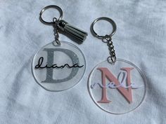 two keychains with letters on them that say d, n, and delta