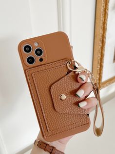 a woman holding a brown cell phone case