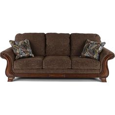 a brown couch with two pillows on it