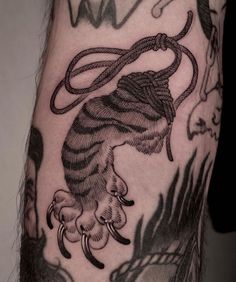 a close up of a person's arm with tattoos on it and an octopus