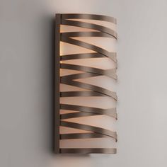 a wall mounted light that is on the side of a wall with an interesting design