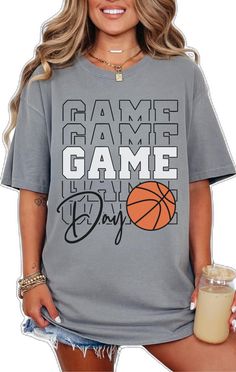 a woman holding a drink and wearing a t - shirt that says game day