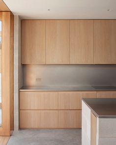 an empty kitchen with wooden cabinets and stainless steel counter tops