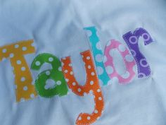 the word baby spelled out with polka dots on a white t - shirt that says it's a boy