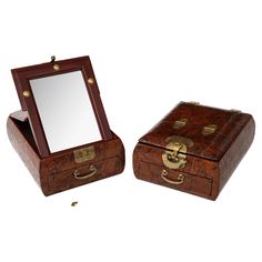 two wooden boxes with mirrors in them on a white background, one is open and the other is closed