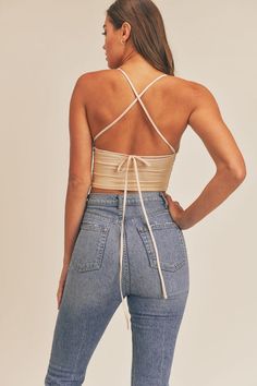 Halter mesh crop top with back lace up detail. FABRIC & FIT: Model is wearing size Small.