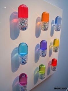 there are many different colored nail polishes on the wall