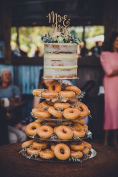 a wedding cake and donuts stacked on top of each other