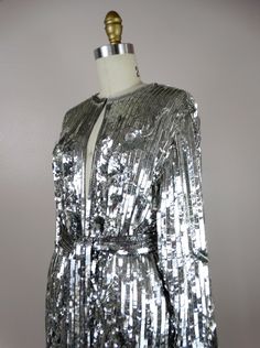 "This is another AMAZING vintage piece! It's fully embellished with eye-catching reflective sequins and is in perfect condition! Measurements: Bust - 40\" Shoulders - 16\" Sleeves - 21\" Top to Bottom - 31\" All of my items come from a smoke-free and pet-free home. If you have any questions, please don't hesitate to ask!" Silver Sequined Evening Outerwear, Metallic Sequined Party Outerwear, Silk Sequined Long Sleeve Outerwear, Luxury Long Sleeve Sequined Outerwear, Vintage Sequin Fitted Outerwear, Checkered Jacket, Mirror Silver, Sequin Jacket, Beaded Gown