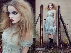 a woman with long blonde hair and makeup is posing in front of an old door