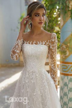 a woman in a white wedding dress posing for the camera