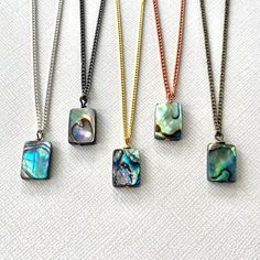 The abalone shell necklace is a minimalist piece of jewelry for women, designed as a boho layered seashell necklace in silver, brass, gold, gunmetal and copper. This meaningful gift makes a perfect birthday present for mom or a thoughtful gift for her. 🪶 𝗠𝗔𝗧𝗘𝗥𝗜𝗔𝗟𝗦 + 𝗗𝗜𝗠𝗘𝗡𝗦𝗜𝗢𝗡𝗦 ❯  Pendant measures 1 inch long ❯  Abalone shell, Brass, Copper, Silver-plated, Gold-plated chain + Matching  Lobster Claw Clasp 🪶 𝗦𝗧𝗢𝗡𝗘 + 𝗘𝗟𝗘𝗠𝗘𝗡𝗧 𝗘𝗡𝗘𝗥𝗚𝗬 ❯  ABALONE is known for warding off negative energy 🪶 𝗣𝗘𝗥𝗦𝗢𝗡𝗔𝗟𝗜𝗭𝗔𝗧𝗜𝗢𝗡 + 𝗚𝗜𝗙𝗧 𝗦𝗘𝗧 𝗦𝗨𝗚𝗚𝗘𝗦𝗧𝗜𝗢𝗡𝗦 ❯  Abalone Earrings (photo 8)  -- lorenlavinedesigns.etsy.com/listing/1400537184 ❯  Abalone Hoop Earrings (photo 9) -- lorenlavinedesigns.etsy.com/listing/941482067 🪶 𝗬𝗢𝗨 𝗠𝗜𝗚𝗛𝗧 𝗟𝗜𝗞𝗘 ❯  Shop Abalone Shell Necklace, Necklace Minimalist Jewelry, Gift For Mom Birthday, Birthday Presents For Mom, Abalone Earrings, Thoughtful Gifts For Her, Seashell Necklace, Presents For Mom, Necklace Minimalist