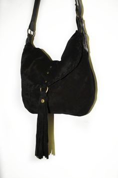 Crossbody bag made with soft black suede and stronger brown leather. This bag has a soft structure and a very strong shoulder strap made with high quality leather. The bag is a medium size messenger with a slightly rounded shape and a soft structure, the flap is embellished by a suede seam and a beautiful suede tassel. The shoulder strap width is 0.8 inch. The shoulder bag is adjustable with a beautiful buckle. The bag is unlined and there aren't pockets inside. Features : - Black suede, - Black Suede Hobo Bag With Leather Handles, Suede Soft Leather Hobo Shoulder Bag, Suede Soft Leather Hobo Bag, Soft Leather Suede Hobo Bag, Suede Lined Hobo Shoulder Bag, Suede Shoulder Bag With Textured Leather For Daily Use, Suede Satchel Shoulder Bag With Leather Handles, Suede Crossbody Hobo Bag For Everyday Use, Suede Hobo Bag With Adjustable Strap For Travel