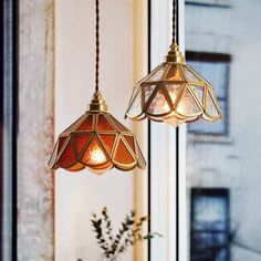 two lights hanging from a ceiling in a room