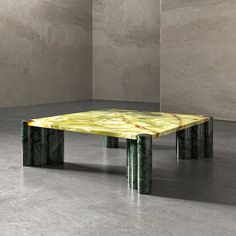 a table made out of marble with two columns in the middle and one column at the end