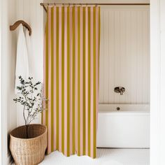 a white bath tub sitting next to a shower curtain