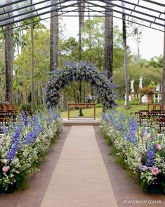 a walkway lined with blue and white flowers