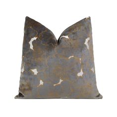 a gray and gold pillow with white stars on the front, sitting on a white background