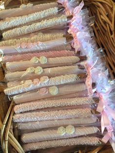 several bundles of pink and white candy wrapped in cellophane with bows on them