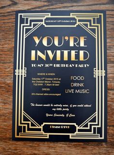 a black and gold party card with the words you're in it