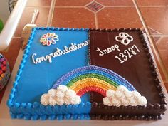 two cakes with rainbows and congratulations written on them