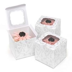 three white boxes with pink flowers in them