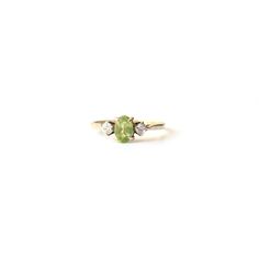 A stunning 9ct gold Peridot ring. This classic ring features a pale hued green Peridot gems flanked by two CZ stones.  This is a very eye catching ring, we do hope the photos do this piece justice. A beautiful & unique 9ct gold ring featuring August's birthstone!  This ring comes presented in a Milly's Marvel's gift box hand tied with green satin ribbon. All other boxes are for display purpose only. RING SIZE - US Size 5 3/4 UK M Hallmarks - 375 an anchor, date letter G to inside of ring shank WEIGHT - 1.2grams CONDITION - This ring is offered in very good condition. This is a vintage pre-loved ring so will show signs of use & wear. Please review all photos carefully. LAYAWAY - This ring qualifies for our layaway payment plan, please get in touch for details. SHIPPING Worldwide shipping is Green 14k Gold Ring With Accent Stones, 14k Gold Green Rings With Accent Stones, Green 14k Gold Rings With Accent Stones, Classic Green Birthstone Ring With Accent Stones, Green 14k Gold Birthstone Ring With Accent Stones, Green Diamond Multi-stone Birthstone Ring, Green Multi-stone Diamond Ring In 14k Gold, Multi-stone Green Diamond Ring In 14k Gold, Green Multi-stone 14k Gold Diamond Ring