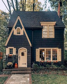 a black house with white trim and windows