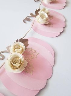 pink and white paper flowers on a string