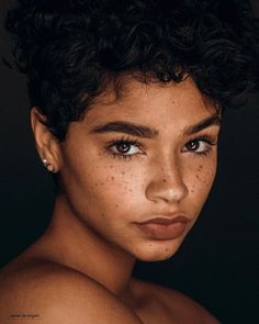 a woman with freckles on her face and chest is looking at the camera